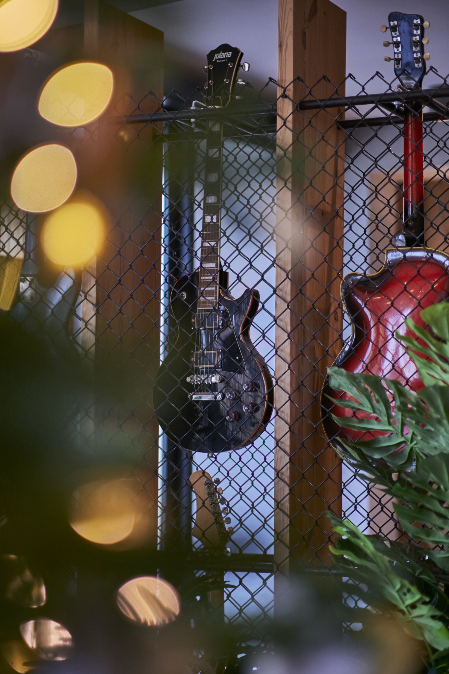 Guitar hung up in restaurant to go along with the rock theme and interior design language.