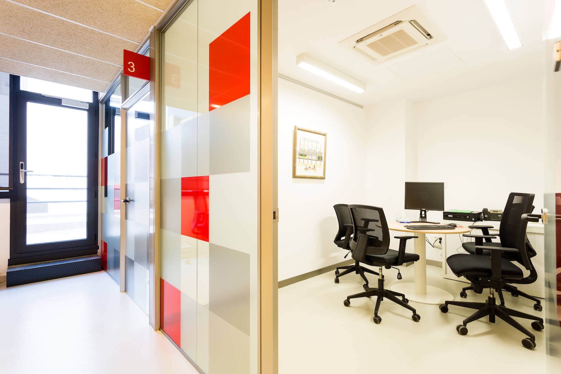 Office meeting room behind glass door